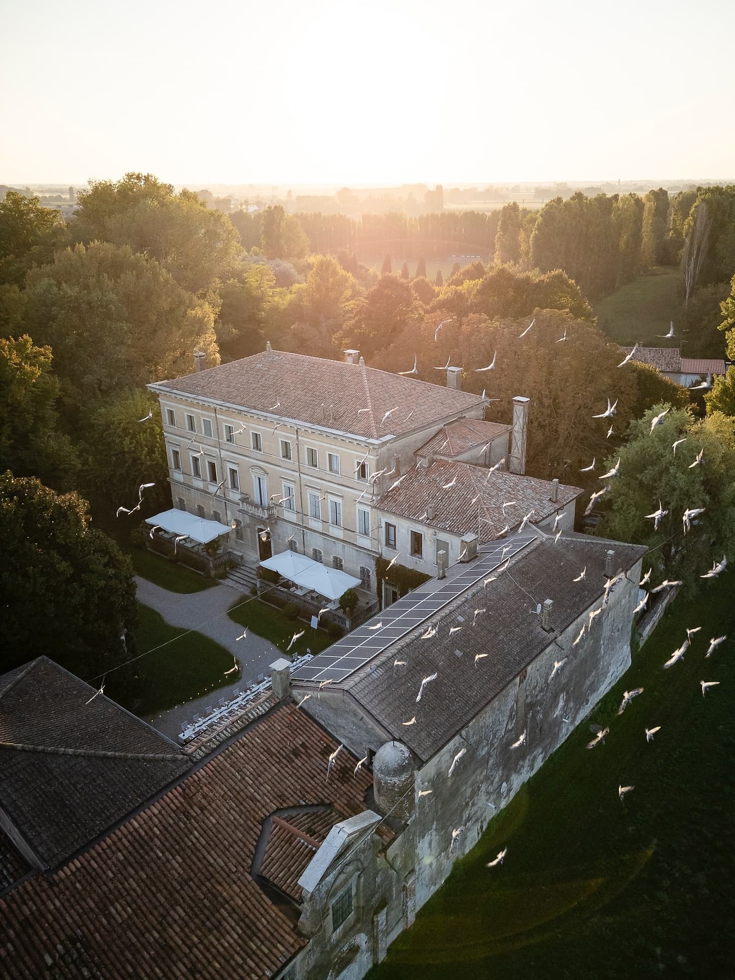 The villa and its grounds from above at sunrise